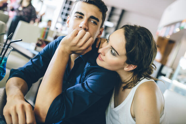 woman resting chin on boyfriend's shoulder