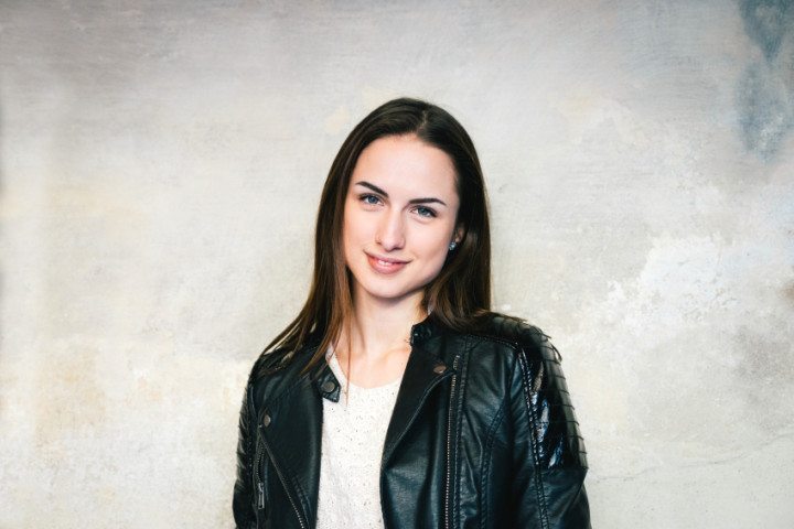 smiling woman's portait against wall