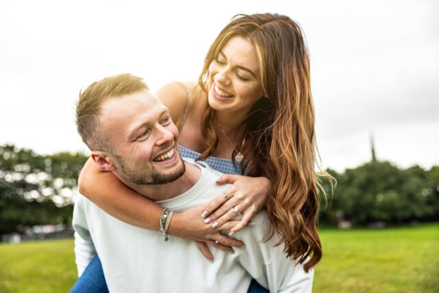 woman riding piggyback on boyfriend