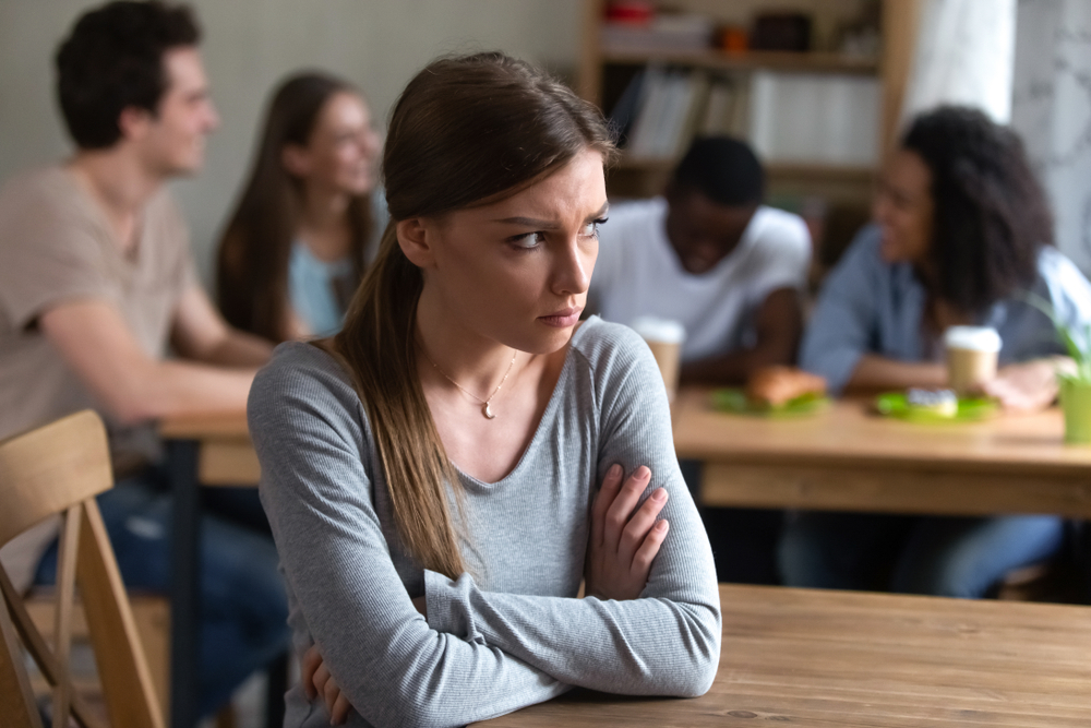 Abused,Upset,Offended,By,Friends,Young,Caucasian,Woman,Sitting,Alone