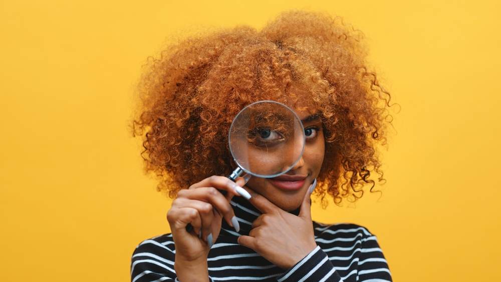 Funny,Young,African,American,Black,Woman,With,Magnifier,In,Hand