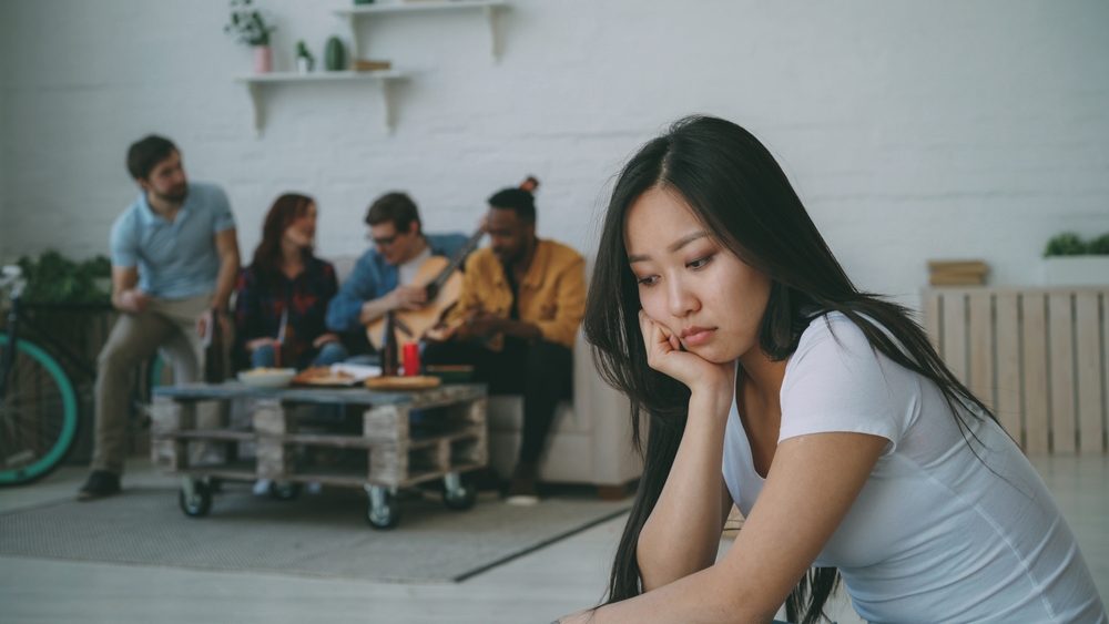 Young,Asian,Girl,Feels,Upset,And,Isolated,While,Her,Flatmates, left out