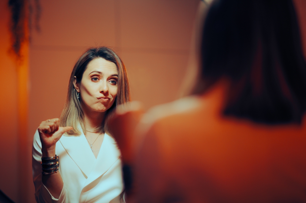 Vain,Woman,Pointing,To,Herself,Looking,In,The,Mirror.,Smug