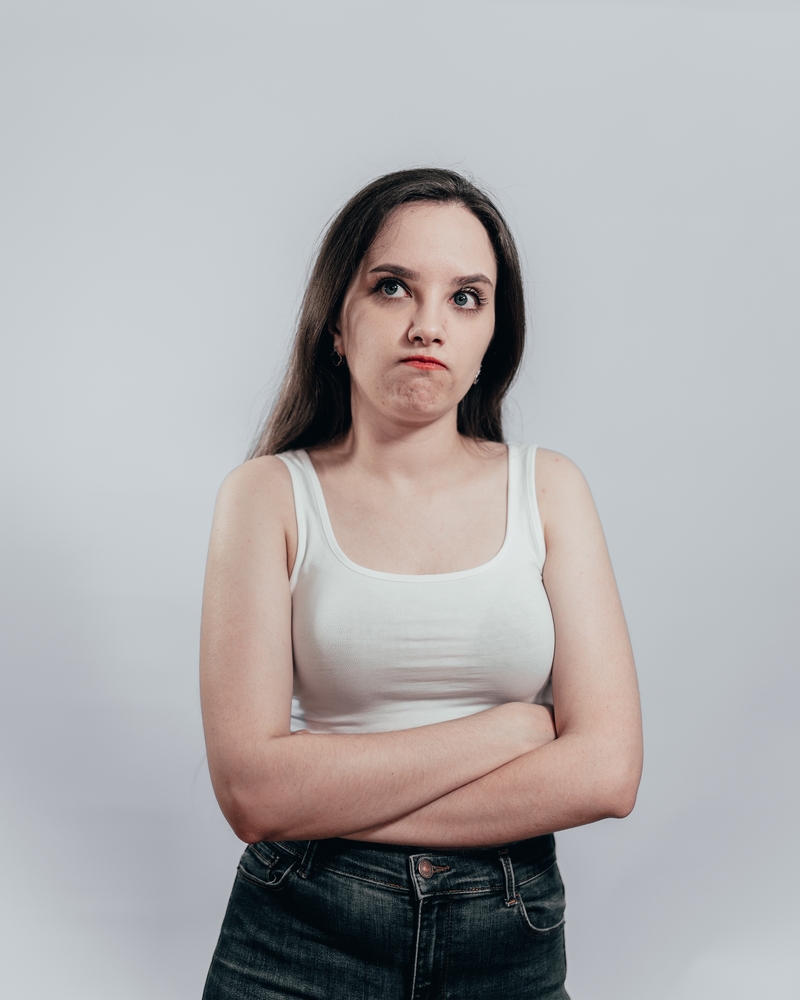 Unhappy,And,Grudging,Woman,In,A,White,Sleeveless,Top,And