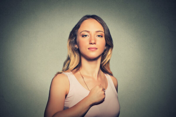 Superhero,Girl.,Confident,Young,Woman,Isolated,On,Gray,Wall,Background